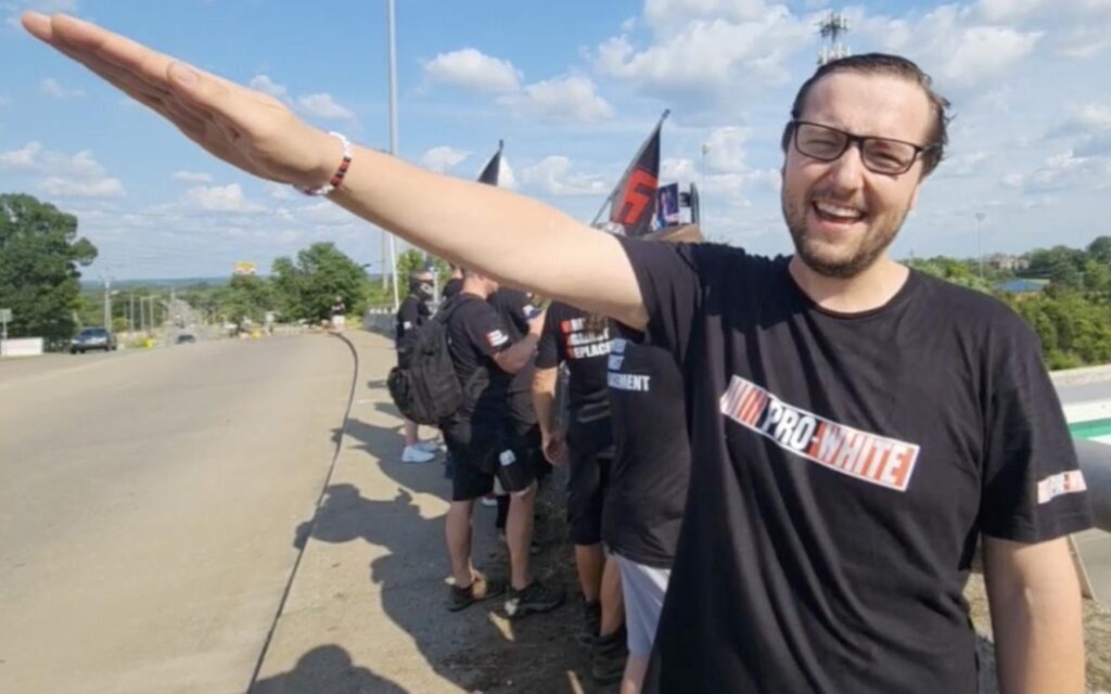 Photo of GDL member Antoni Stipan Knezovic of Ontario, Canada throwing a Nazi salute during a banner drop in Nashville on July 15, 2024.