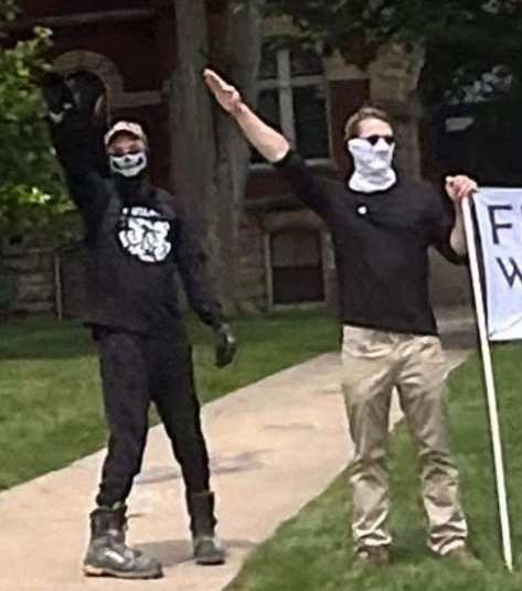 Two people performing a nazi salute in front of the Howell courthouse